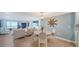 Bright dining area with modern furnishings, hard wood floors, and a view of the ocean at 420 Beach Rd # 502, Sarasota, FL 34242