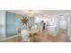 Bright kitchen and dining area with stainless steel appliances, white cabinetry, and hardwood floors at 420 Beach Rd # 502, Sarasota, FL 34242