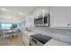 Bright kitchen with stainless steel appliances, marble countertops and views of the ocean view living and dining space at 420 Beach Rd # 502, Sarasota, FL 34242