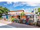 Vibrant restaurant exterior with colorful decor, patio seating, and lush plants under a sunny sky at 420 Beach Rd # 502, Sarasota, FL 34242
