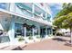 Quaint three-story store exterior with festive decorations, plants, and ample storefront windows at 420 Beach Rd # 502, Sarasota, FL 34242
