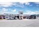 Wide shot of Siesta Market storefront with ample parking and clear signage under a partly cloudy sky at 420 Beach Rd # 502, Sarasota, FL 34242