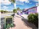 Charming street view with colorful buildings, sidewalk, and happy hour advertisement board at 420 Beach Rd # 502, Sarasota, FL 34242