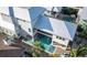 Aerial shot of a luxury home with a backyard swimming pool and modern architecture at 421 Spring Ave, Anna Maria, FL 34216