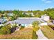 Aerial view of a home with a metal roof, large yard, and storage shed at 4416 58Th W St, Bradenton, FL 34210