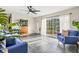 Sunlit living room with large windows, modern decor, and stylish gray tile floors at 4416 58Th W St, Bradenton, FL 34210