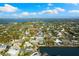Aerial view of the home near a quiet neighborhood, lush landscaping, and a pond at 4646 Gleason Ave, Sarasota, FL 34242