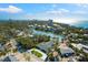 Coastal community featuring beautiful residential houses, blue water, and vibrant landscapes under a sunny sky at 4646 Gleason Ave, Sarasota, FL 34242