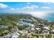 Breathtaking aerial view of a coastal community featuring luxury homes, blue water, and vibrant landscapes under a sunny sky at 4646 Gleason Ave, Sarasota, FL 34242