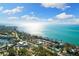Beautiful aerial view capturing the coastline, sparkling ocean, and charming beachfront homes with lush greenery at 4646 Gleason Ave, Sarasota, FL 34242
