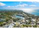 Aerial view of coastal home with lush landscaping and a pond in a tranquil neighborhood at 4646 Gleason Ave, Sarasota, FL 34242