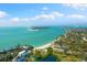 Panoramic aerial view showcasing pristine turquoise waters, white sandy beaches, and coastal homes in a beautiful community at 4646 Gleason Ave, Sarasota, FL 34242