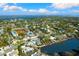 Picturesque waterfront home with a private pool and lush green landscaping, offering serene coastal living at 4646 Gleason Ave, Sarasota, FL 34242