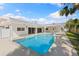 Beautiful backyard pool and patio area with a covered lanai, ceiling fans, and lush tropical landscaping at 4646 Gleason Ave, Sarasota, FL 34242