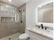 Modern bathroom with a glass-enclosed shower, updated vanity, and a sleek, illuminated mirror at 4646 Gleason Ave, Sarasota, FL 34242