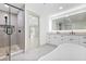 Elegant bathroom with a shower, double vanity, and a luxurious tub at 4646 Gleason Ave, Sarasota, FL 34242