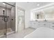 Luxurious bathroom featuring a soaking tub, double vanity, and a glass shower with modern finishes at 4646 Gleason Ave, Sarasota, FL 34242