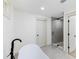 Bathroom showcasing a modern soaking tub and glass enclosed shower with neutral color palette at 4646 Gleason Ave, Sarasota, FL 34242