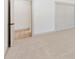 Bright bedroom featuring a large closet and doorway to another room with neutral carpet at 4646 Gleason Ave, Sarasota, FL 34242