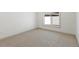 Cozy bedroom featuring neutral carpet, a large window and white trim throughout at 4646 Gleason Ave, Sarasota, FL 34242