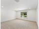 Spacious bedroom with neutral carpet, a large window offering natural light, and a clean, modern aesthetic at 4646 Gleason Ave, Sarasota, FL 34242