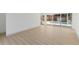 Bright bonus room with wood-look floors and views to the pool through sliding glass doors at 4646 Gleason Ave, Sarasota, FL 34242