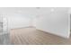 Spacious, well-lit room with light wood flooring and clean, white walls, creating a minimalist aesthetic at 4646 Gleason Ave, Sarasota, FL 34242