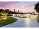 Beautifully landscaped home featuring a long driveway with elegant exterior lighting at dusk at 4646 Gleason Ave, Sarasota, FL 34242