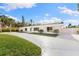 Inviting single-story home with a well-maintained lawn, a long driveway, and a fenced yard for privacy at 4646 Gleason Ave, Sarasota, FL 34242