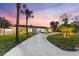 Charming single-story home with a manicured lawn and a long, winding driveway at 4646 Gleason Ave, Sarasota, FL 34242