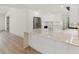 Modern kitchen featuring stainless steel appliances, white cabinetry, and hardwood flooring at 4646 Gleason Ave, Sarasota, FL 34242