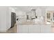 Modern kitchen featuring stainless steel appliances, white cabinetry, and hardwood flooring at 4646 Gleason Ave, Sarasota, FL 34242