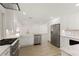 Modern kitchen featuring stainless steel appliances, white cabinetry, and hardwood flooring at 4646 Gleason Ave, Sarasota, FL 34242