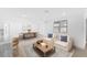 Bright living room featuring neutral furniture, a dining area, and stylish decor on light wood floors at 4646 Gleason Ave, Sarasota, FL 34242