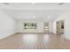 Bright living room featuring light wood floors, neutral walls, and a large window with natural light at 4646 Gleason Ave, Sarasota, FL 34242