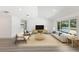 Bright living room features a neutral palette, stylish furniture, a textured rug, and sliding glass doors to the outdoors at 4646 Gleason Ave, Sarasota, FL 34242