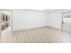 Contemporary living space featuring light wood floors, neutral paint and access to the outdoor patio at 4646 Gleason Ave, Sarasota, FL 34242
