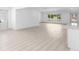 Open floor plan with light wood floors, large window, and neutral walls providing a bright, airy feel at 4646 Gleason Ave, Sarasota, FL 34242