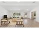 Inviting living room with stylish furniture, neutral colors, and natural light from the large windows at 4646 Gleason Ave, Sarasota, FL 34242