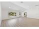 Bright living room with recessed lighting, large windows with neighborhood views, and modern flooring at 4646 Gleason Ave, Sarasota, FL 34242
