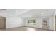 Spacious living room featuring lots of natural light, an exterior door, and hardwood floors at 4646 Gleason Ave, Sarasota, FL 34242