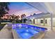 Stunning outdoor pool and spa with covered patio and beautiful waterfront views at dusk at 4646 Gleason Ave, Sarasota, FL 34242