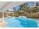 Inviting backyard pool featuring a spa, water feature, and lush landscaping for ultimate relaxation and privacy at 4646 Gleason Ave, Sarasota, FL 34242