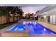 Inviting pool and spa with ambient lighting and tropical landscaping, perfect for evening relaxation at 4646 Gleason Ave, Sarasota, FL 34242