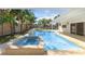 Pool with spa overlooking the lake, framed by palm trees at 4646 Gleason Ave, Sarasota, FL 34242