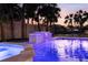 Tranquil pool and spa featuring illuminated waterfalls, nestled amidst lush tropical foliage at 4646 Gleason Ave, Sarasota, FL 34242