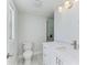 Bright bathroom with white vanity, toilet, and glass walk-in shower at 502 69Th St, Holmes Beach, FL 34217
