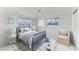 Cozy bedroom with a blue color scheme, featuring a twin bed and comfortable armchair at 502 69Th St, Holmes Beach, FL 34217