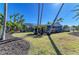 Landscaped yard with palms and lush grass surround the beautiful exterior of the home at 502 69Th St, Holmes Beach, FL 34217