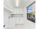 Clean laundry room with built-in cabinets, a countertop, and a window for natural light at 502 69Th St, Holmes Beach, FL 34217